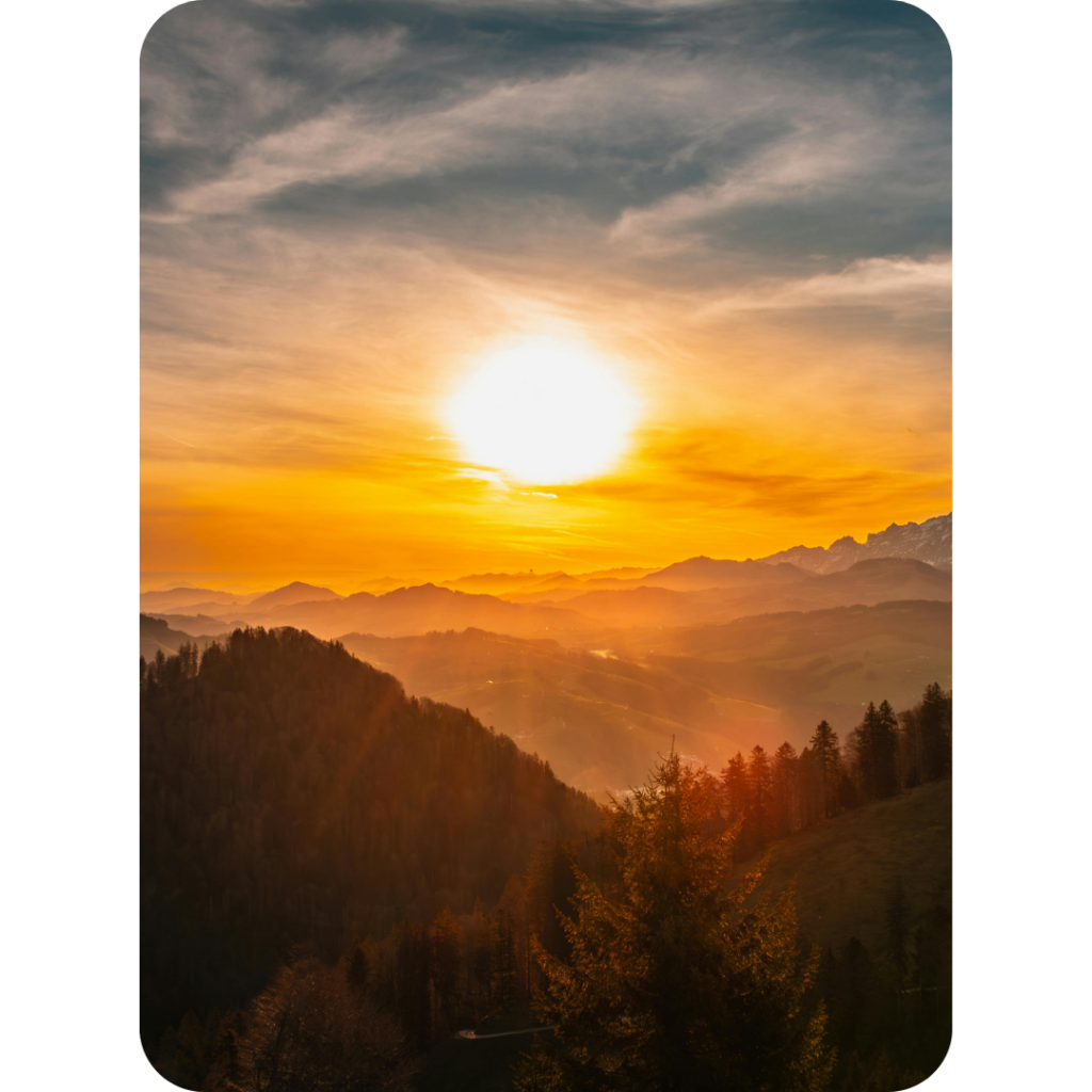 Golden sunrise illuminating a peaceful mountain landscape with rolling hills and forests, symbolizing hope, inner peace, spiritual awakening, mindfulness, and new beginnings.